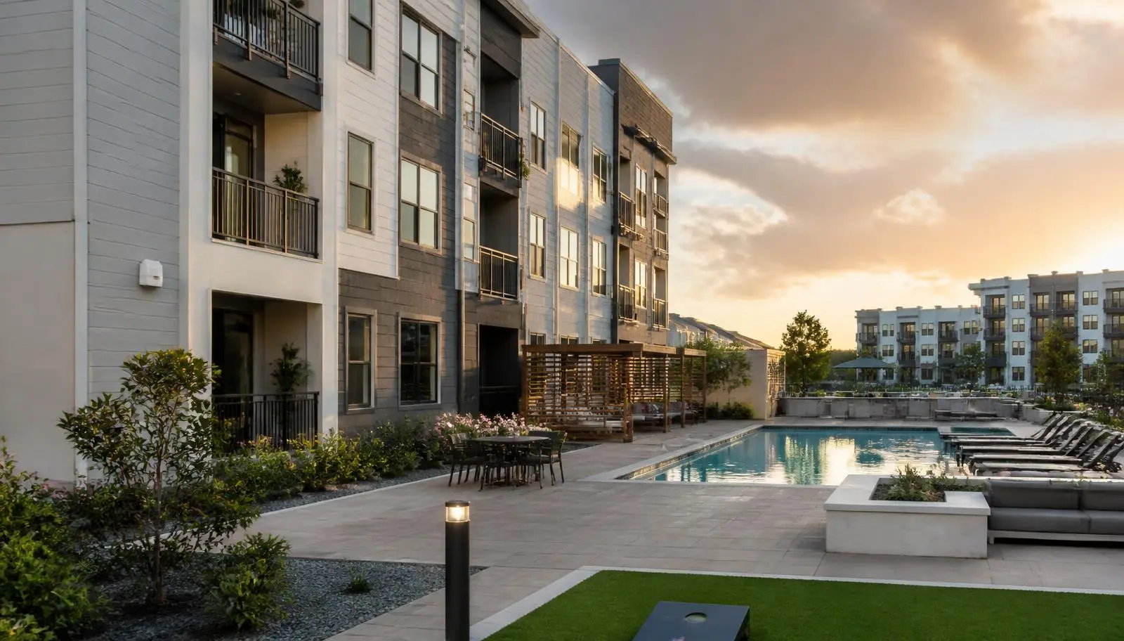 Modern multifamily residential community with courtyard, pool amenity area, and exterior wireless access point